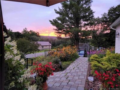 Patio terrace at dusk featuring a storage unit | Image 1