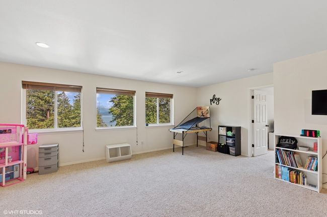 Recreation room with plenty of natural light, carpet floors, baseboards, and recessed lighting | Image 25