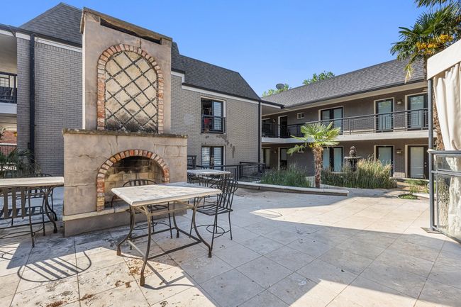 View of patio / terrace with exterior fireplace and outdoor dining area | Image 25