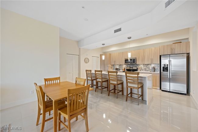 Dining area featuring visible vents, baseboards, and light tile patterned flooring | Image 18