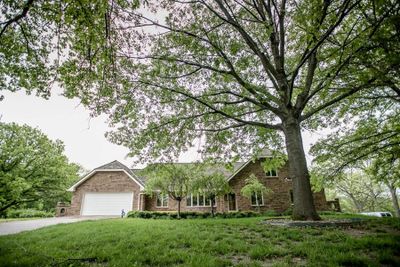 View of front of home with a front lawn and a garage | Image 2