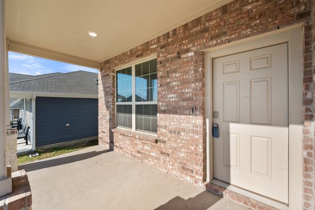 Doorway to property featuring brick siding | Image 36