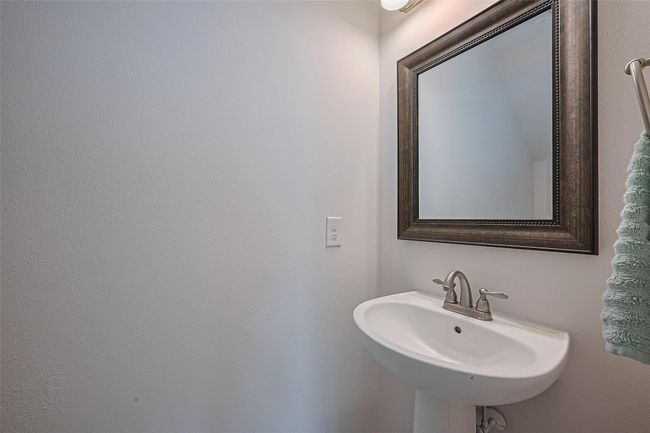 Conveniently located half bath downstairs, perfect for guests and easily accessible from the main living areas. | Image 13