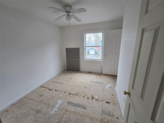 Empty room featuring ceiling fan and baseboards | Image 5