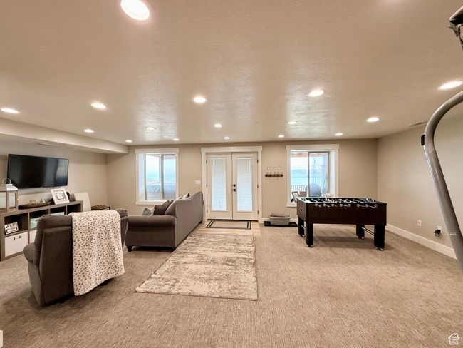 Game room featuring recessed lighting, carpet flooring, a healthy amount of sunlight, and french doors | Image 36