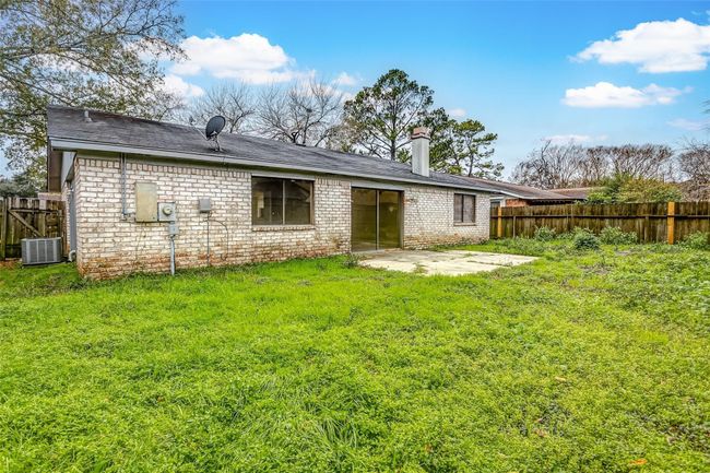 The expansive backyard provides ample space for gardening, recreation, or future landscaping projects. With a spacious patio and plenty of greenery, it’s ideal for enjoying sunny days or hosting outdoor gatherings. | Image 23