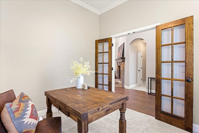 Office with arched walkways, crown molding, french doors, and wood finished floors | Image 29