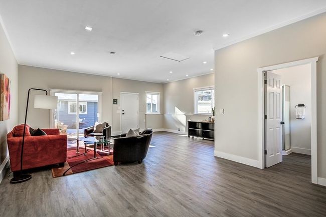 Living room with wood finished floors, baseboards, crown molding, and recessed lighting | Image 22