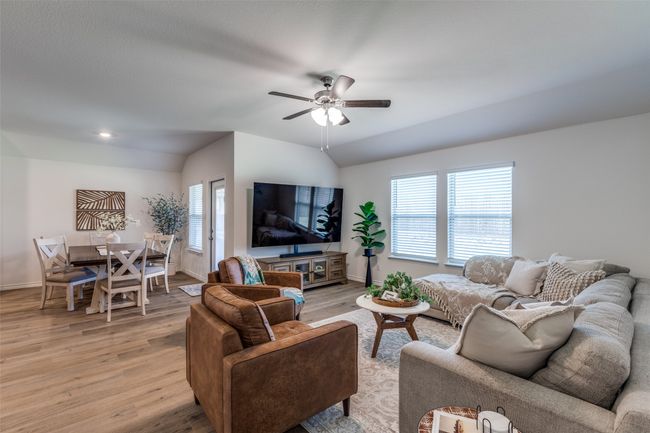 View 3 with light laminated wood plank floors, a ceiling fan, nice bright and light neutral colors. | Image 6