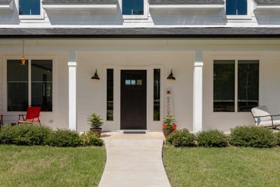 View of exterior entry featuring a lawn and covered porch | Image 2