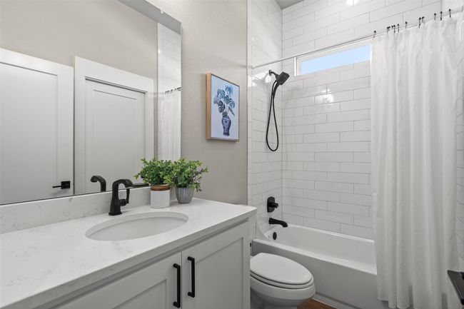 Full bath featuring vanity, shower / tub combo with curtain, and toilet | Image 24