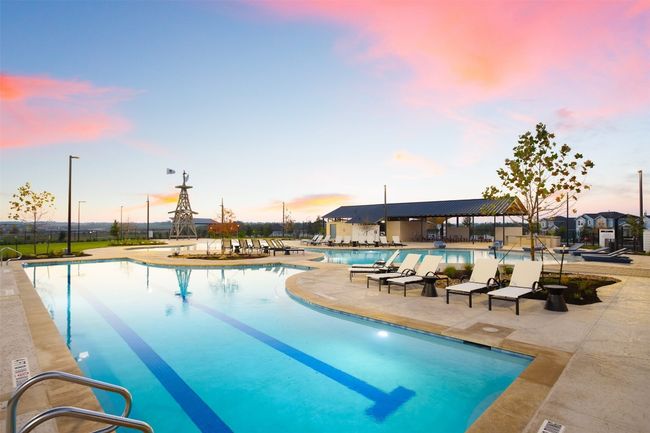 Community pool with a patio area and fence | Image 29