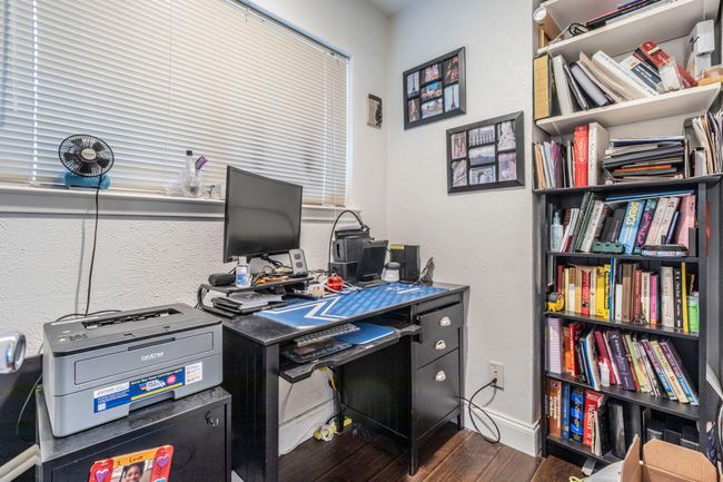 Home office featuring wood finished floors, baseboards, and a textured wall | Image 21