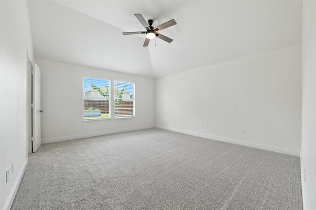 Spare room with carpet flooring, a ceiling fan, and lofted ceiling | Image 19