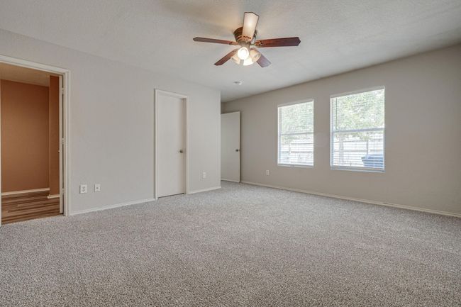 Unfurnished bedroom featuring carpet flooring and a ceiling fan | Image 16