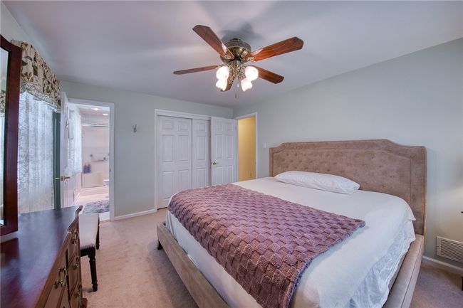Bedroom with newer carpet and hardwood flooring underneath | Image 23