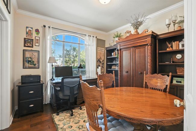 Office area with dark wood-style flooring and ornamental molding | Image 6