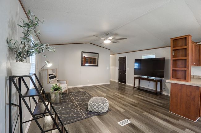 Living area with ceiling fan, dark wood-type flooring, and vaulted ceiling | Image 12