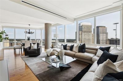 Living room with expansive windows, a chandelier, and hardwood / wood-style flooring | Image 1