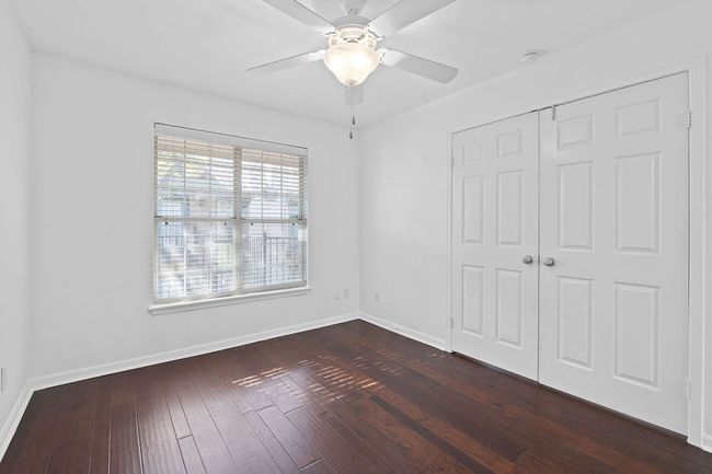 Unfurnished bedroom featuring a closet, baseboards, dark wood finished floors, and a ceiling fan | Image 26