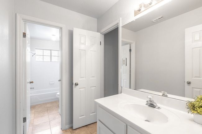 Full bath with vanity, toilet, tile patterned floors, and shower / washtub combination | Image 37