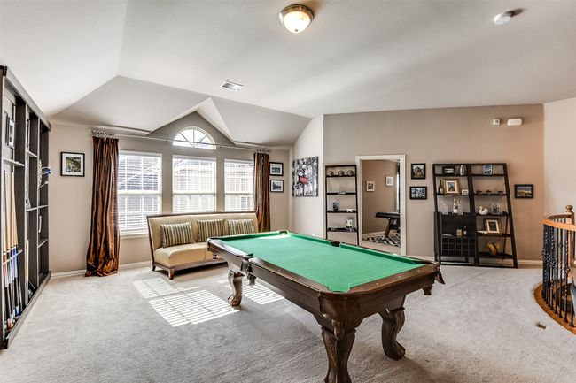 Recreation room with light colored carpet, lofted ceiling, and billiards | Image 33