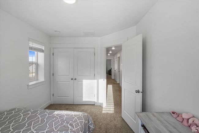 Bedroom with a closet and carpet flooring | Image 15