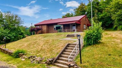 View of front facade with a front lawn | Image 3