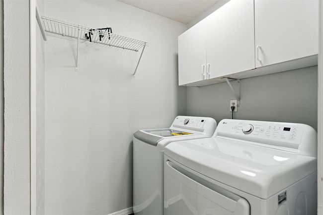 Laundry room featuring cabinet space and washing machine and dryer | Image 20