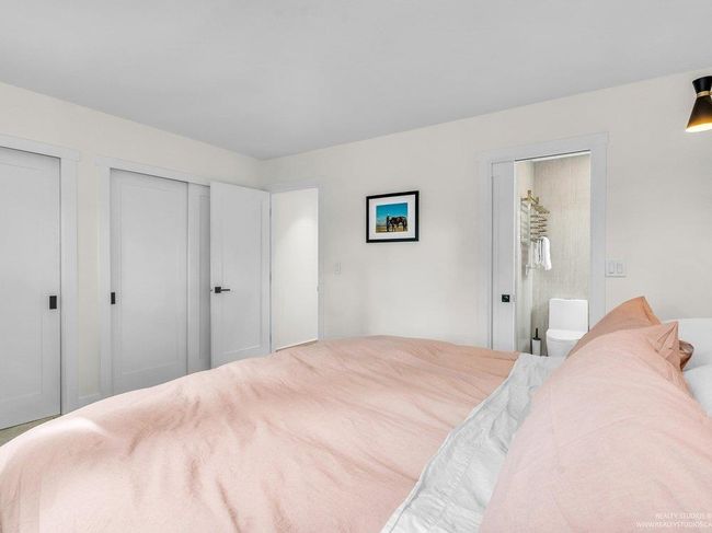 This spacious primary bedroom offers stunning views and privacy thanks to the wall of trees along the fence line. This room features wonderful new closets/systems, doors, windows and a tranquil full ensuite washroom. | Image 25
