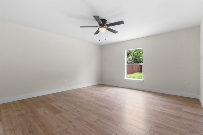 Spare room featuring ceiling fan and light wood finished floors | Image 20