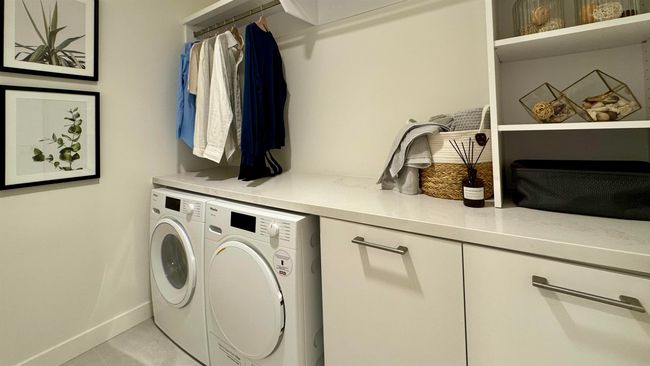 Laundry area featuring separate washer and dryer, baseboards, and laundry area | Image 15