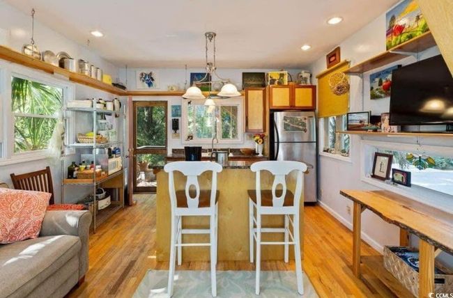Kitchen featuring a sink, light wood-type flooring, freestanding refrigerator, and pendant lighting | Image 9