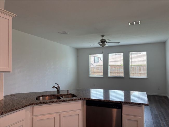 Kitchen with stainless steel dishwasher, a sink, healthy amount of natural light, and ceiling fan | Image 5