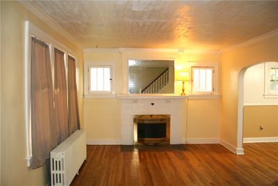 Formal living room w/ crown molding & fireplace | Image 3