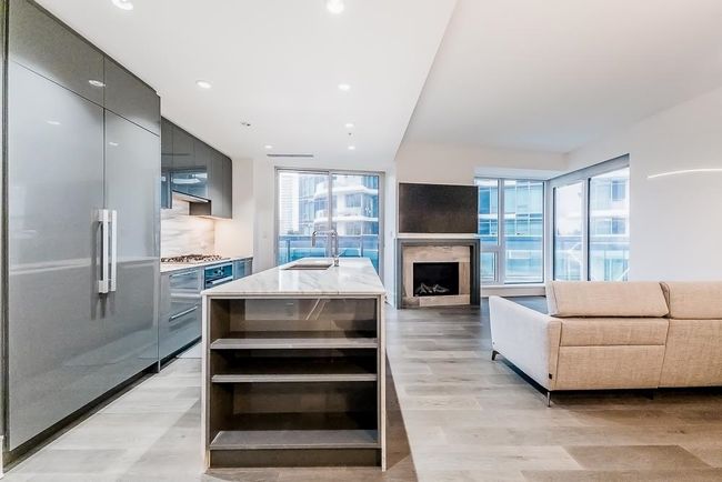 Kitchen with modern cabinets, a healthy amount of sunlight, stainless steel appliances, and a sink | Image 12