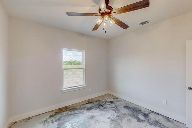 Spare room with visible vents, baseboards, and ceiling fan | Image 22