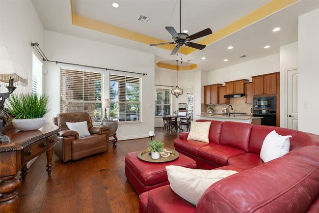 Living room with wood-style flooring, ceiling fan, recessed lighting, and healthy amount of natural light | Image 7