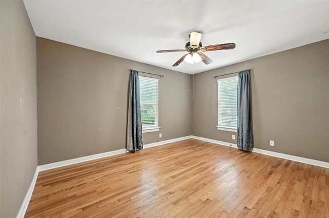Unfurnished bedroom featuring light wood-style flooring, crown molding, a closet, and a ceiling fan | Image 18