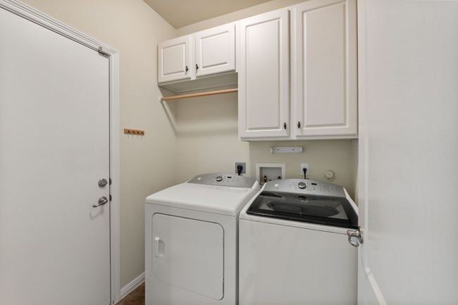 Washroom with separate washer and dryer and cabinet space | Image 22
