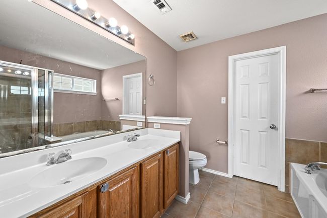 Full bathroom with a bath, tile patterned flooring, double vanity, and a shower stall | Image 21