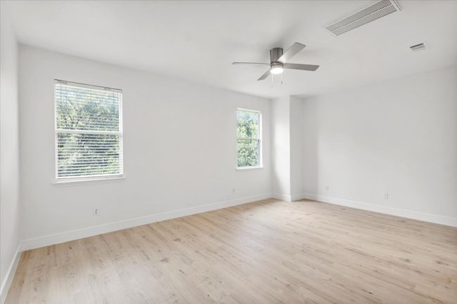 Spare room with light wood-type flooring and a ceiling fan | Image 25