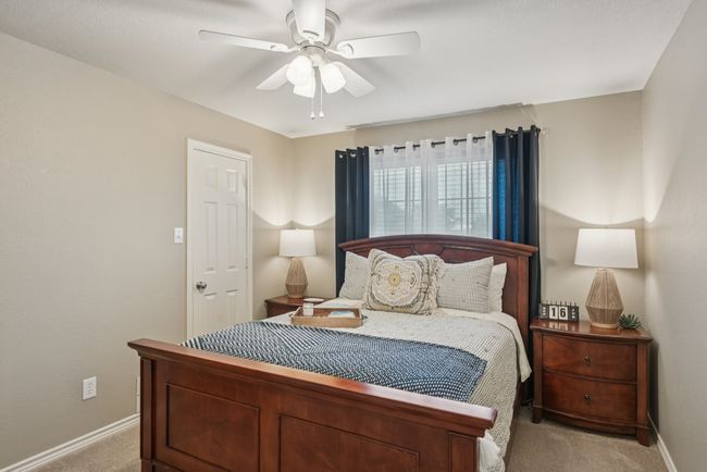 Bedroom featuring light colored carpet and a ceiling fan | Image 25