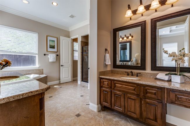 The Primary Ensuite bath offers separate vanities, granite counters and a large oval jetted tub. Also, a very large walk in closet! | Image 15