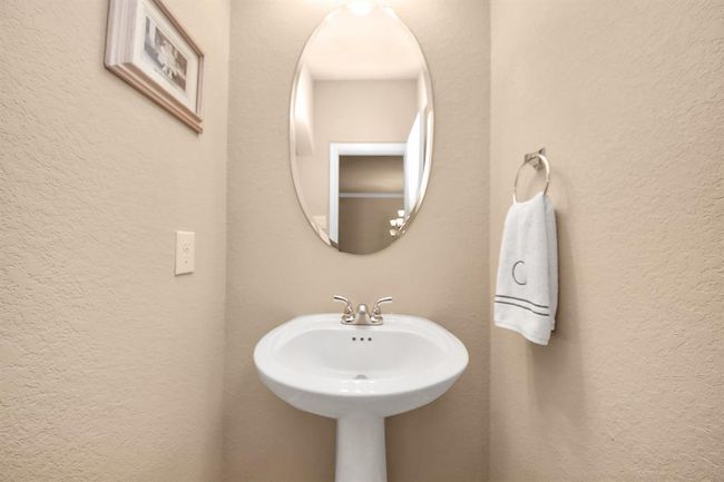 Spacious powder room located off of the entryway. | Image 20
