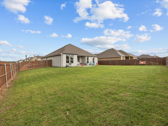 Rear view of property with a fenced backyard, a patio area, and stucco siding | Image 27