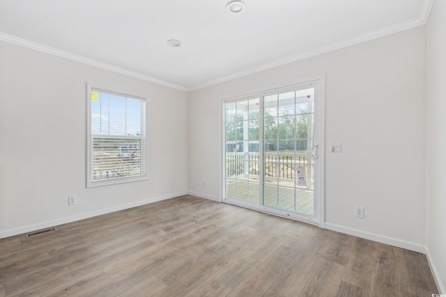 Unfurnished room with ornamental molding, plenty of natural light, and wood finished floors | Image 8