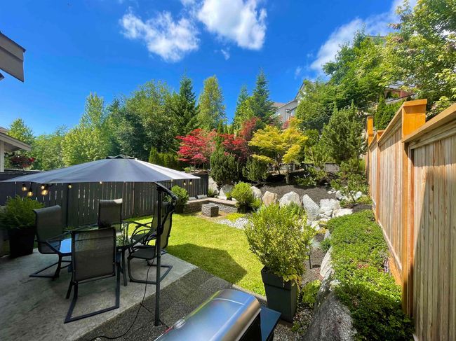 Fenced backyard with a patio and outdoor dining area | Image 33