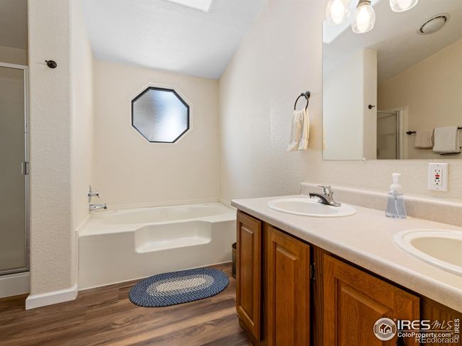 Primary bath has walk in shower and large soaking tub | Image 14