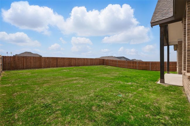 View of yard featuring a fenced backyard and a patio area | Image 29